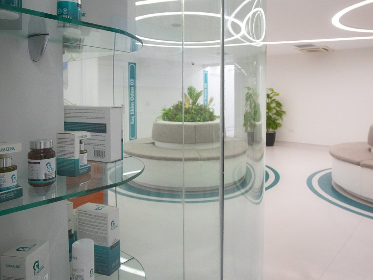 Bright clinic corridor with glass walls and plants in Istanbul